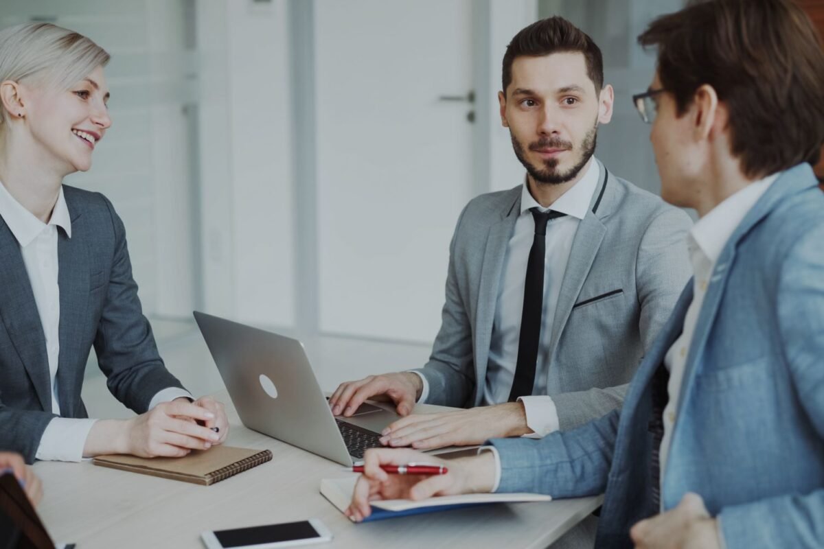Executives in a meeting around a table in a modern office