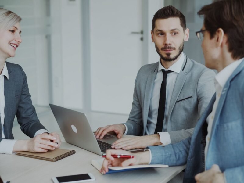 Executives in a meeting around a table in a modern office