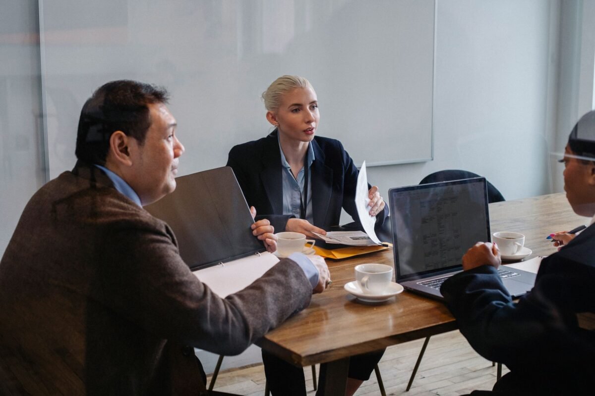 Colleagues discussing business strategy at a desk
