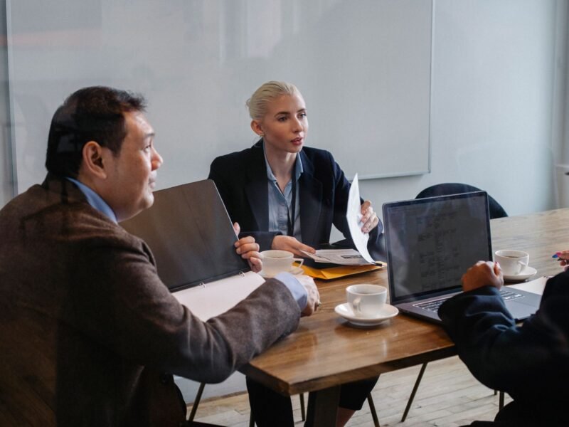 Colleagues discussing business strategy at a desk