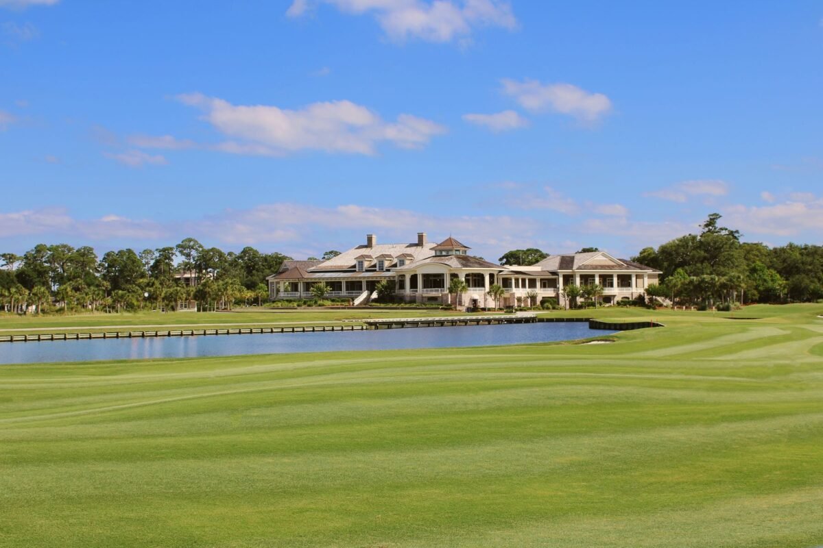 A clubhouse and its approach seen from the course