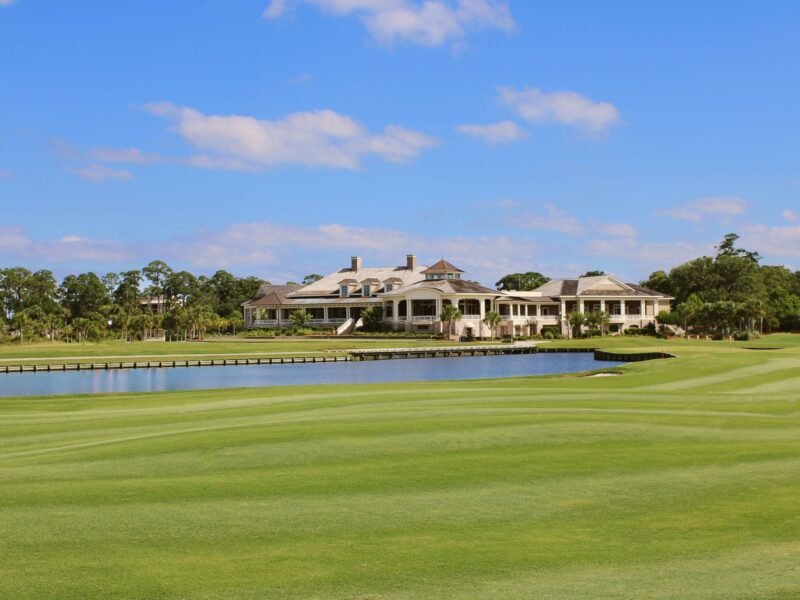A clubhouse and its approach seen from the course