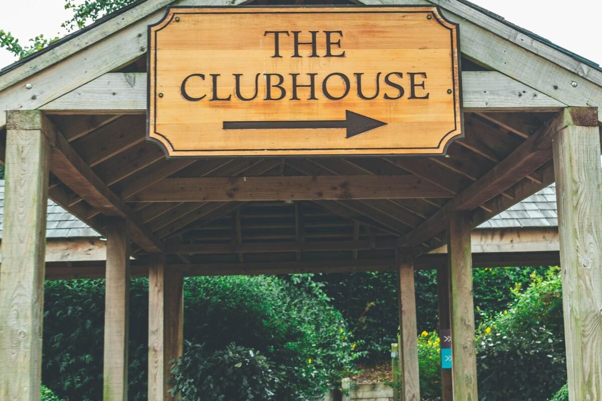A rustic clubhouse entrance sign at a resort course