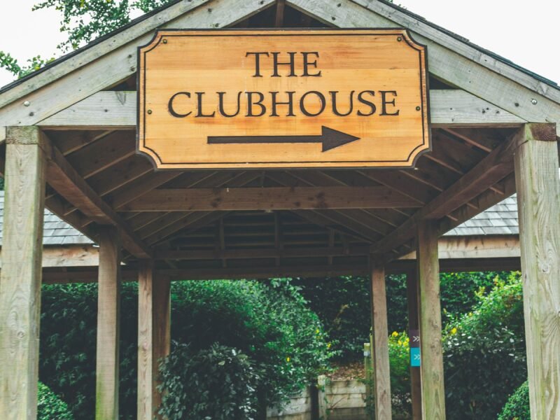 A rustic clubhouse entrance sign at a resort course
