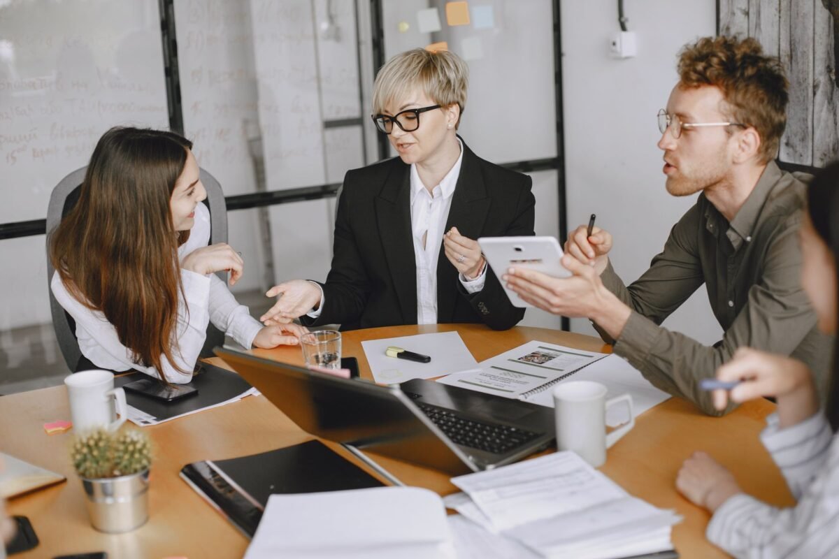 Colleagues in a conference room working through a proposal