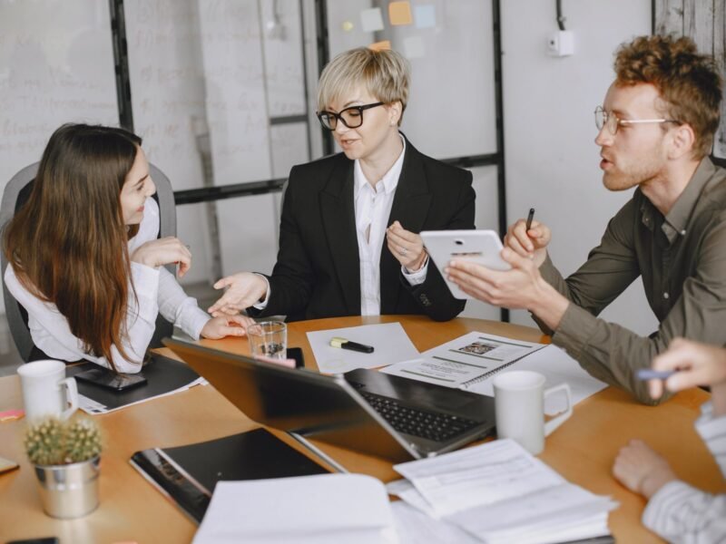 Colleagues in a conference room working through a proposal