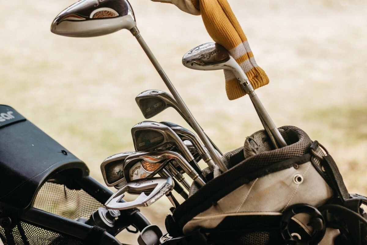 A set of irons standing in a golf bag