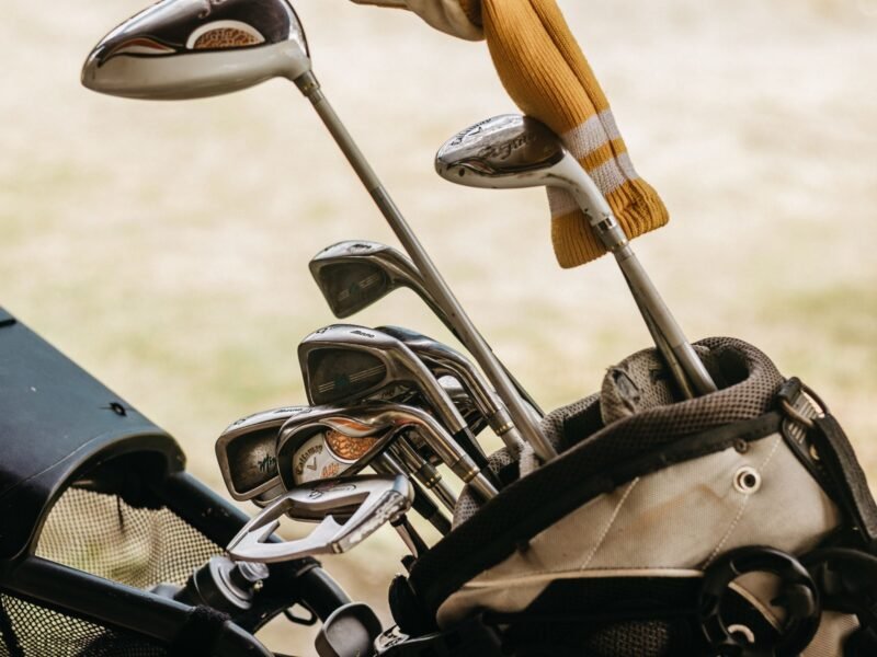 A set of irons standing in a golf bag