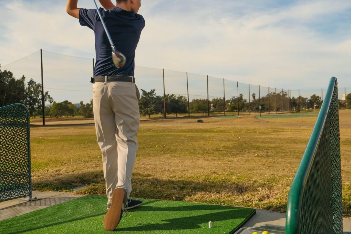 A young player at the finish position of a golf swing