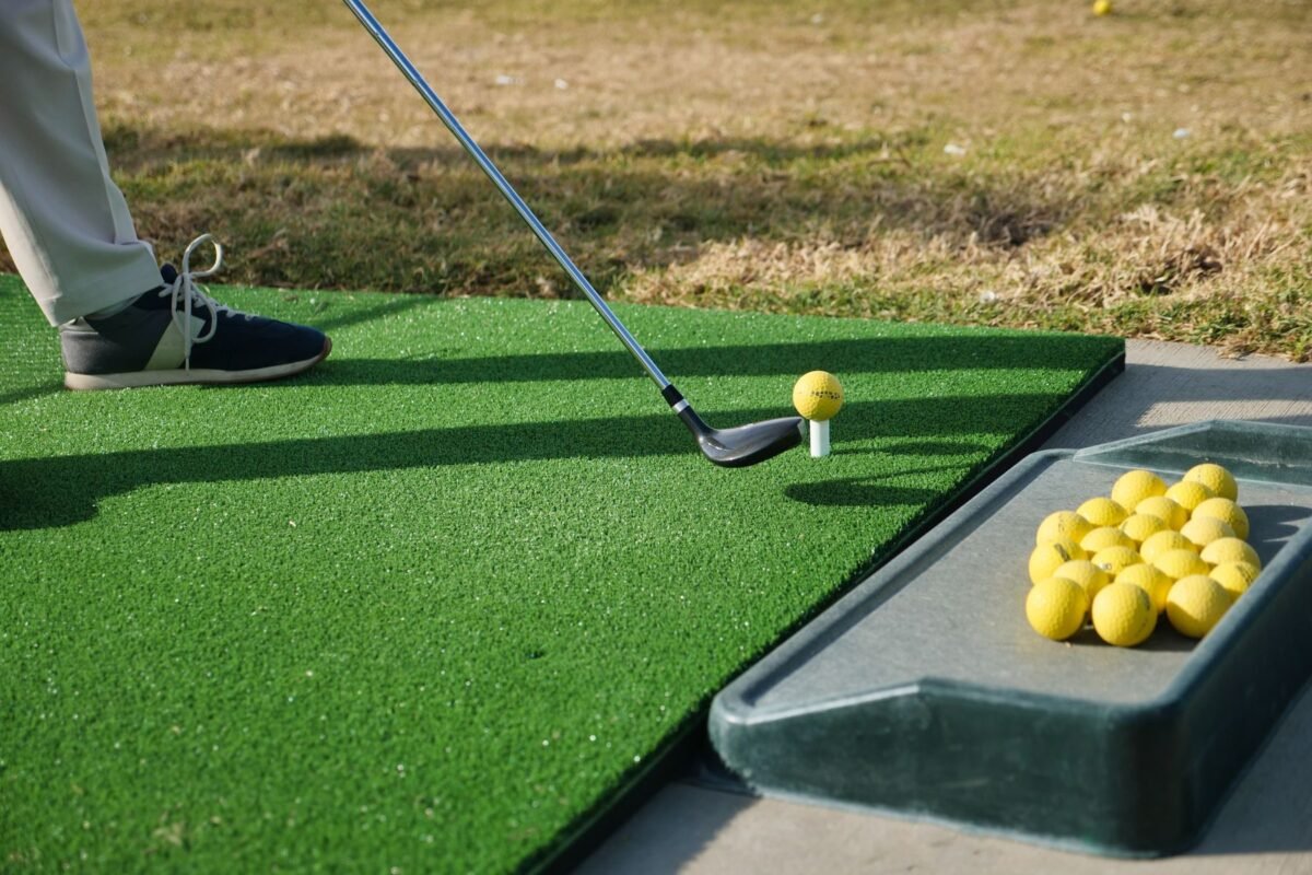 An artificial hitting mat on a driving range bay