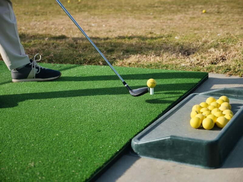 An artificial hitting mat on a driving range bay