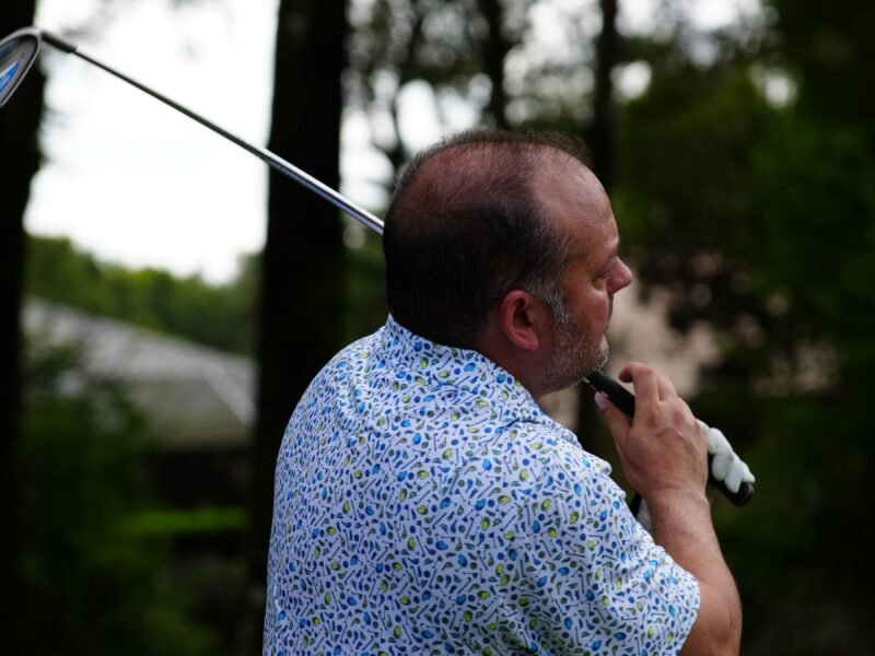 A player standing with a club on the course